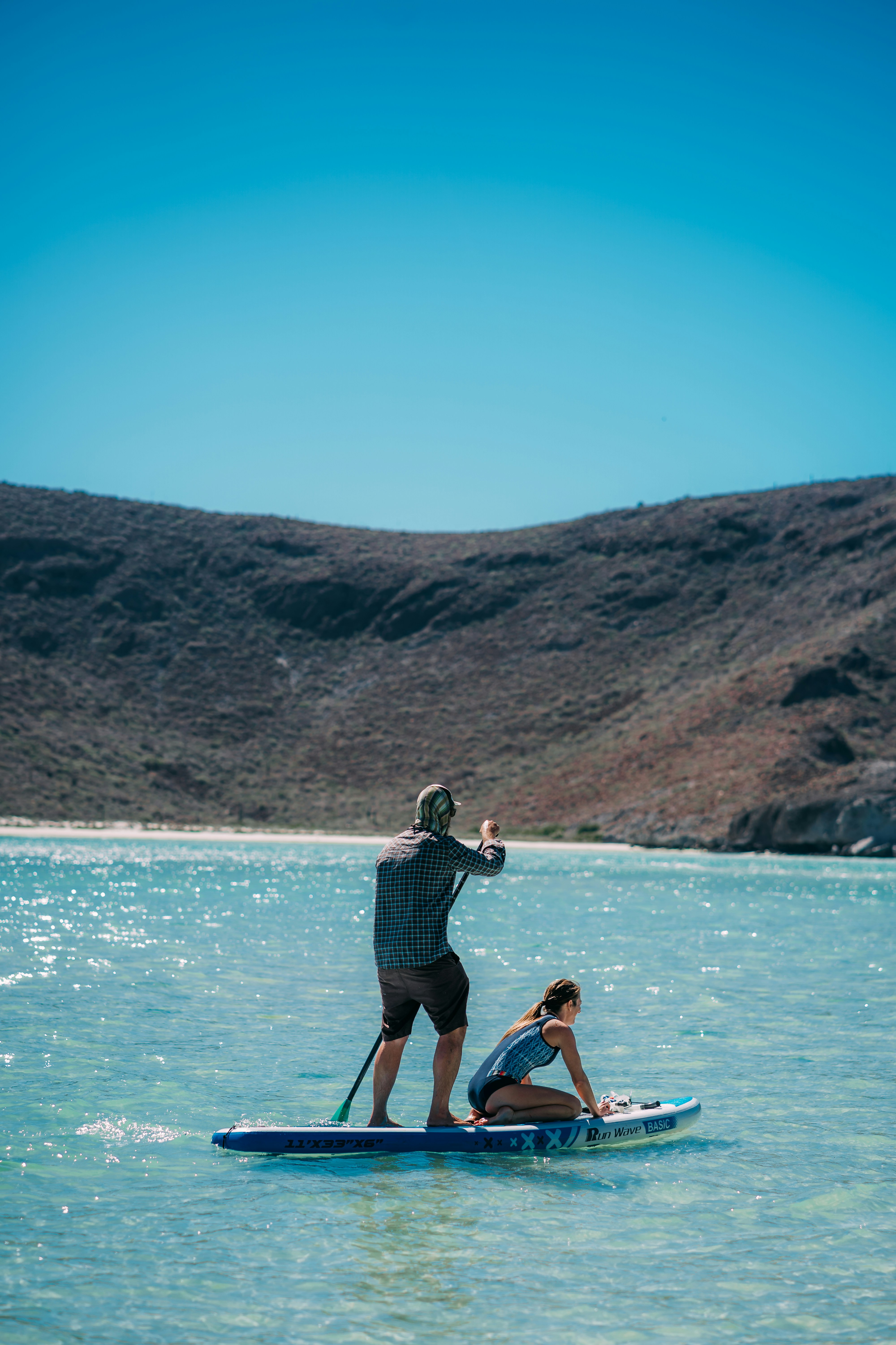 couple paddleboarding on lake
